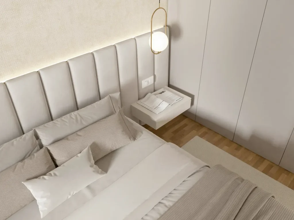 Przykład nowoczesnej sypialni z dużym tapicerowanym zagłówkiem łóżkowym w neutralnym kolorze